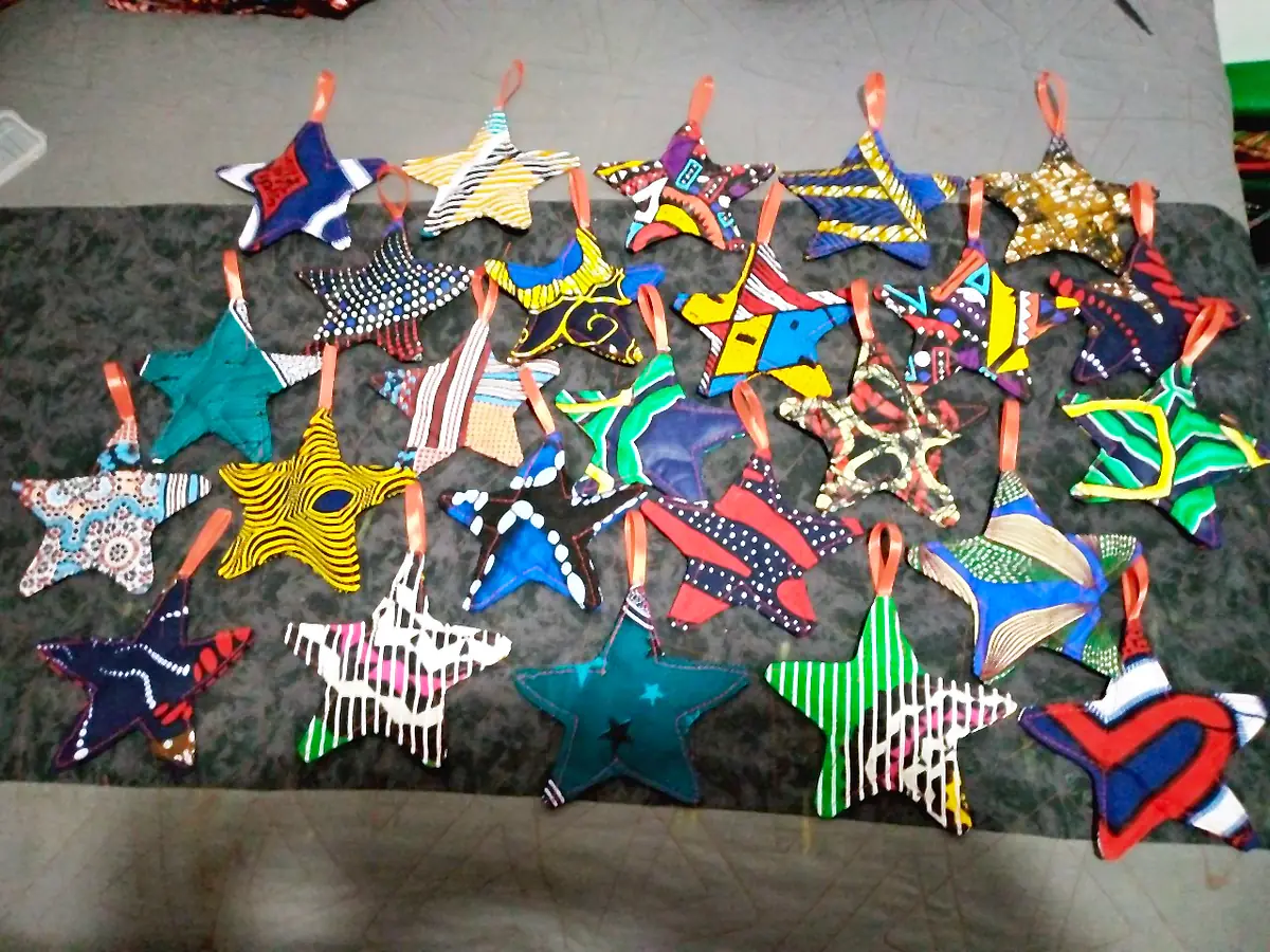Fabric star ornaments in many kitenge prints, each with a ribbon loop