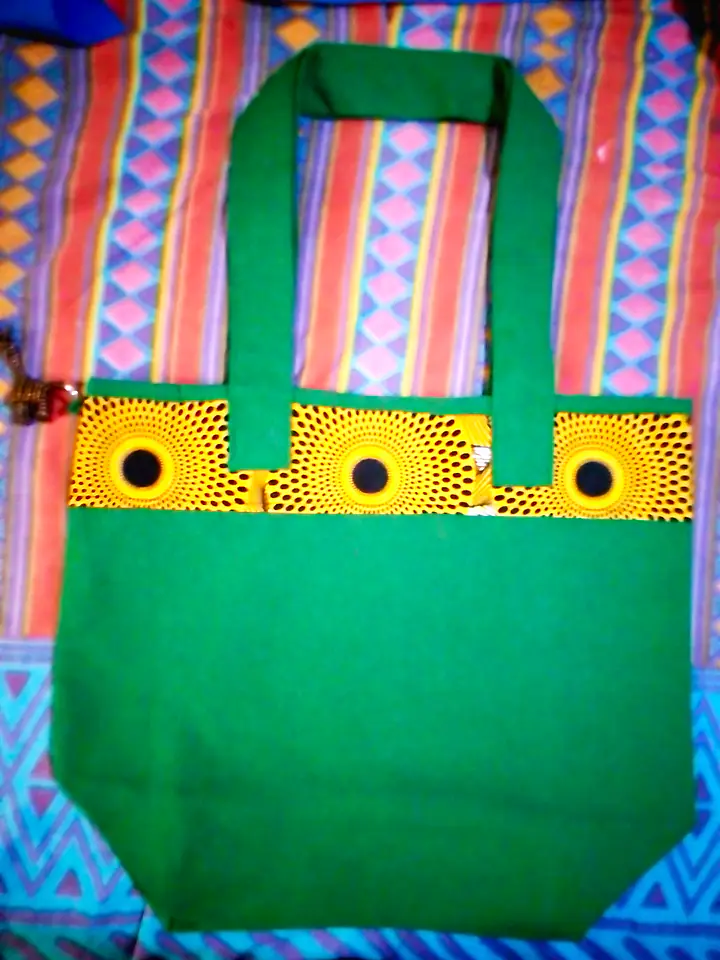Green canvas tote with a band of yellow and black African print