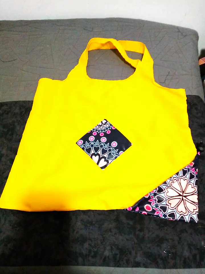 Yellow foldable shopping bag with a patch of African print