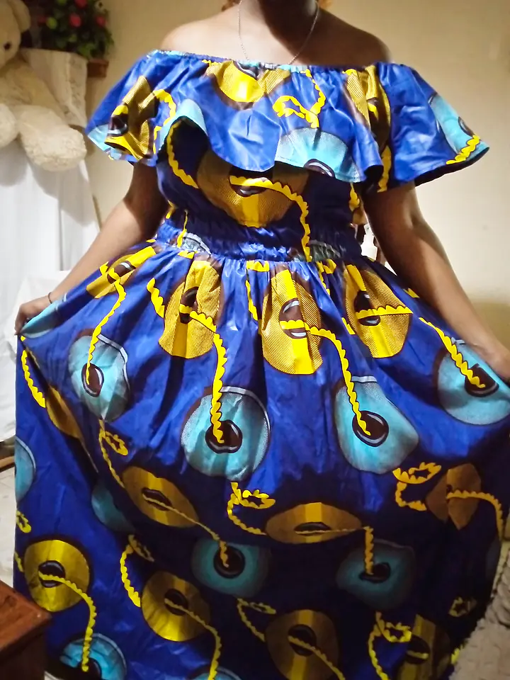 Off-shoulder dress with a ruffled neckline and full skirt in a blue and gold kitenge print