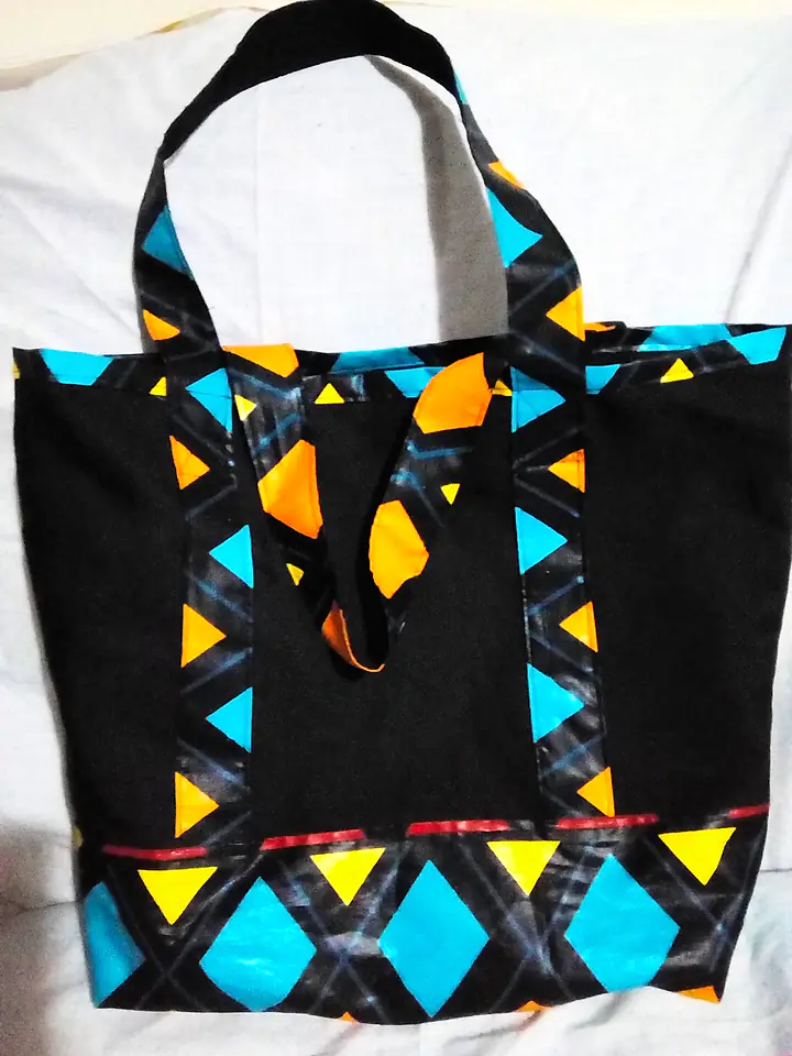 Black canvas tote framed with turquoise, orange and yellow kitenge triangles