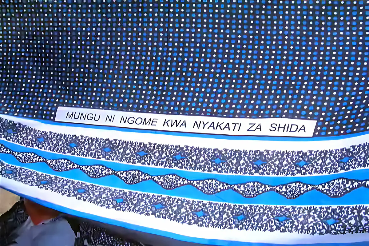 A blue kanga printed with the Swahili proverb Mungu ni ngome kwa nyakati za shida