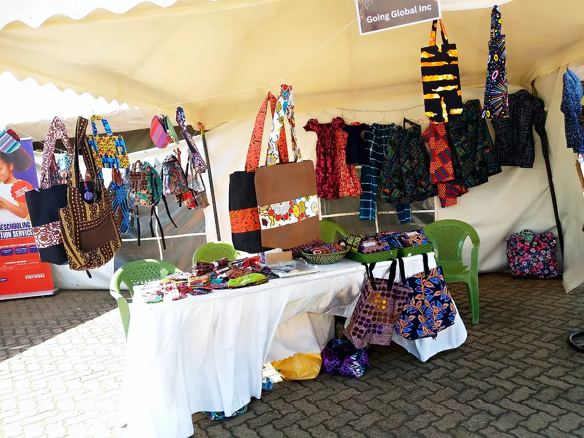 Mary Unique Designs stall at an exhibition, with bags, pouches and dresses on display
