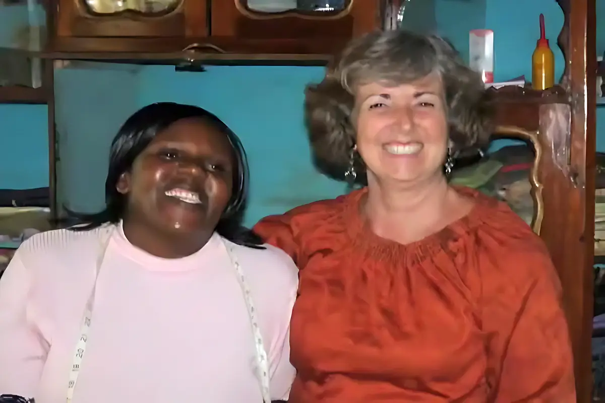 Mary and Linda Renner smiling together in the sewing room